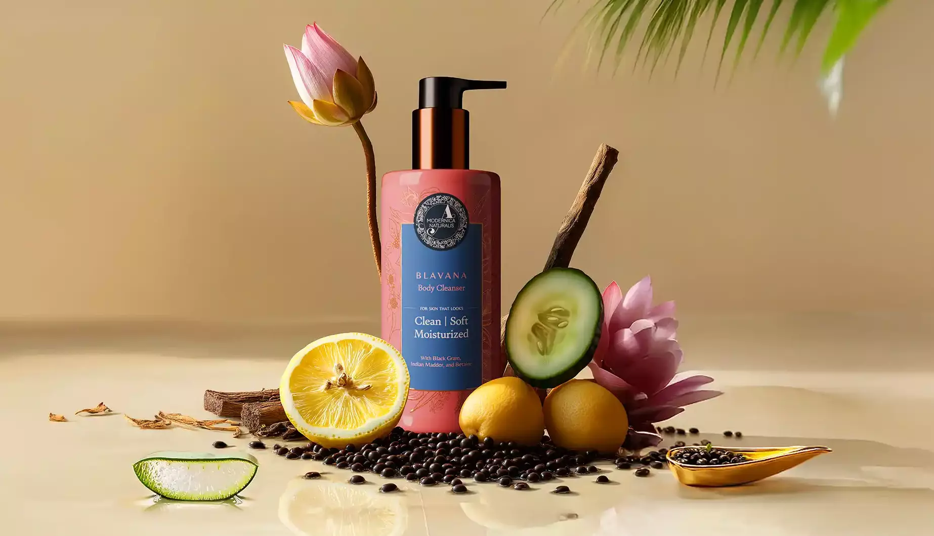 1. The image shows an arrangement of various natural ingredients around the blavana cleanser bottle. Ingredients include: A pink lotus flower Sliced lemons Whole lemons Cucumber slices Black gram manjistha sticks