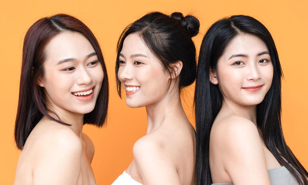Group of three women radiating joy and confidence.