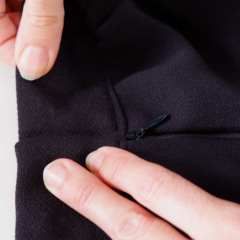 picture showing testing of hook and bar placement on a garment/waistband that has a zipper