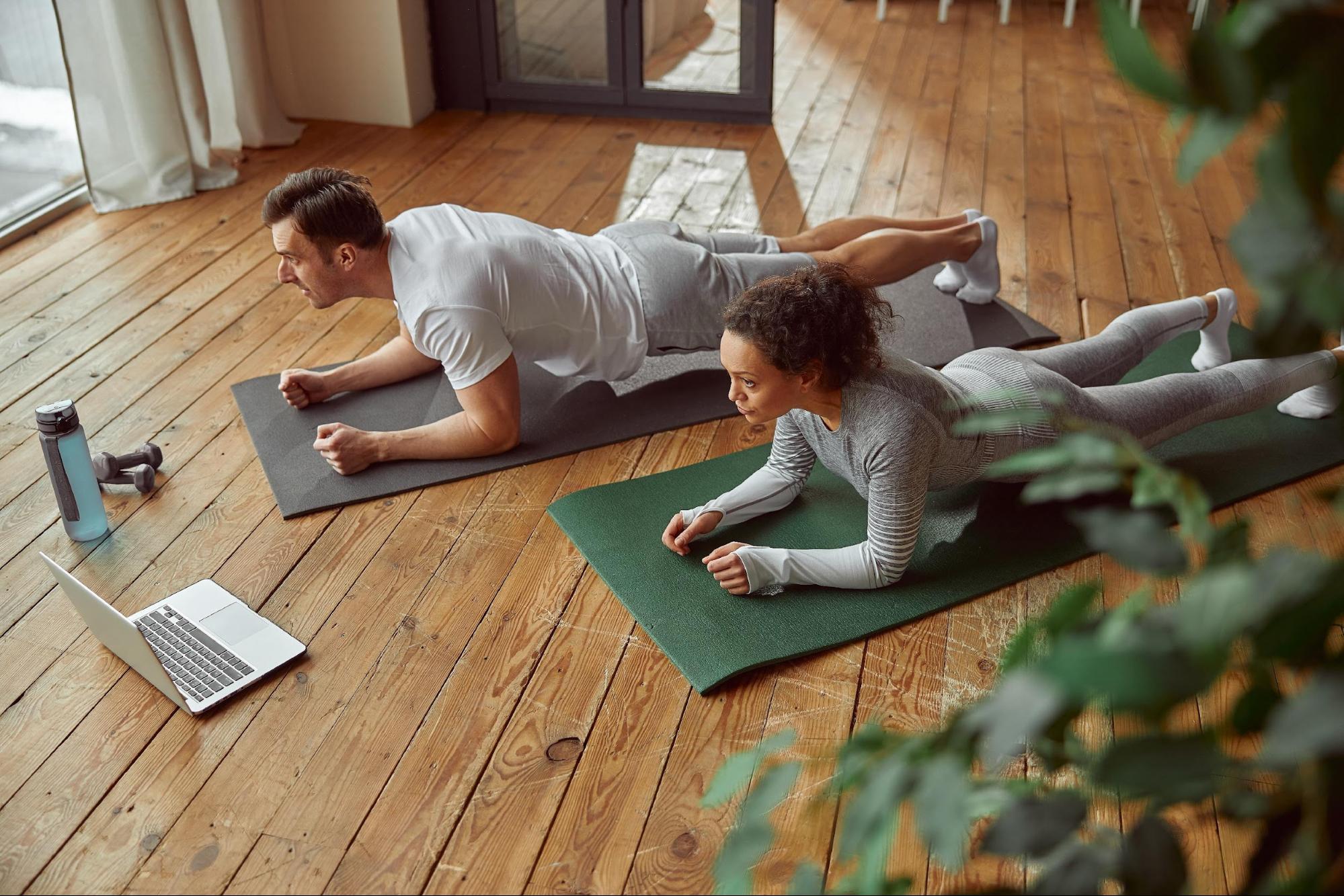 couple workout at home stretch on yoga mat