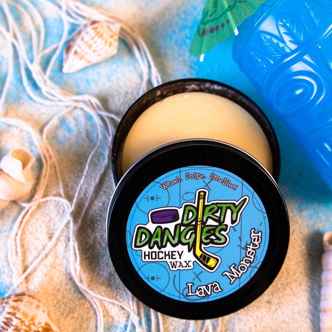 sweet orange and chili pepper scented hockey stick wax on a blue background with sand and beach items. Lava Monster