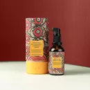 A bottle of Prinourish kept beside it's beautiful, vibrant packaging, in front of a red color background