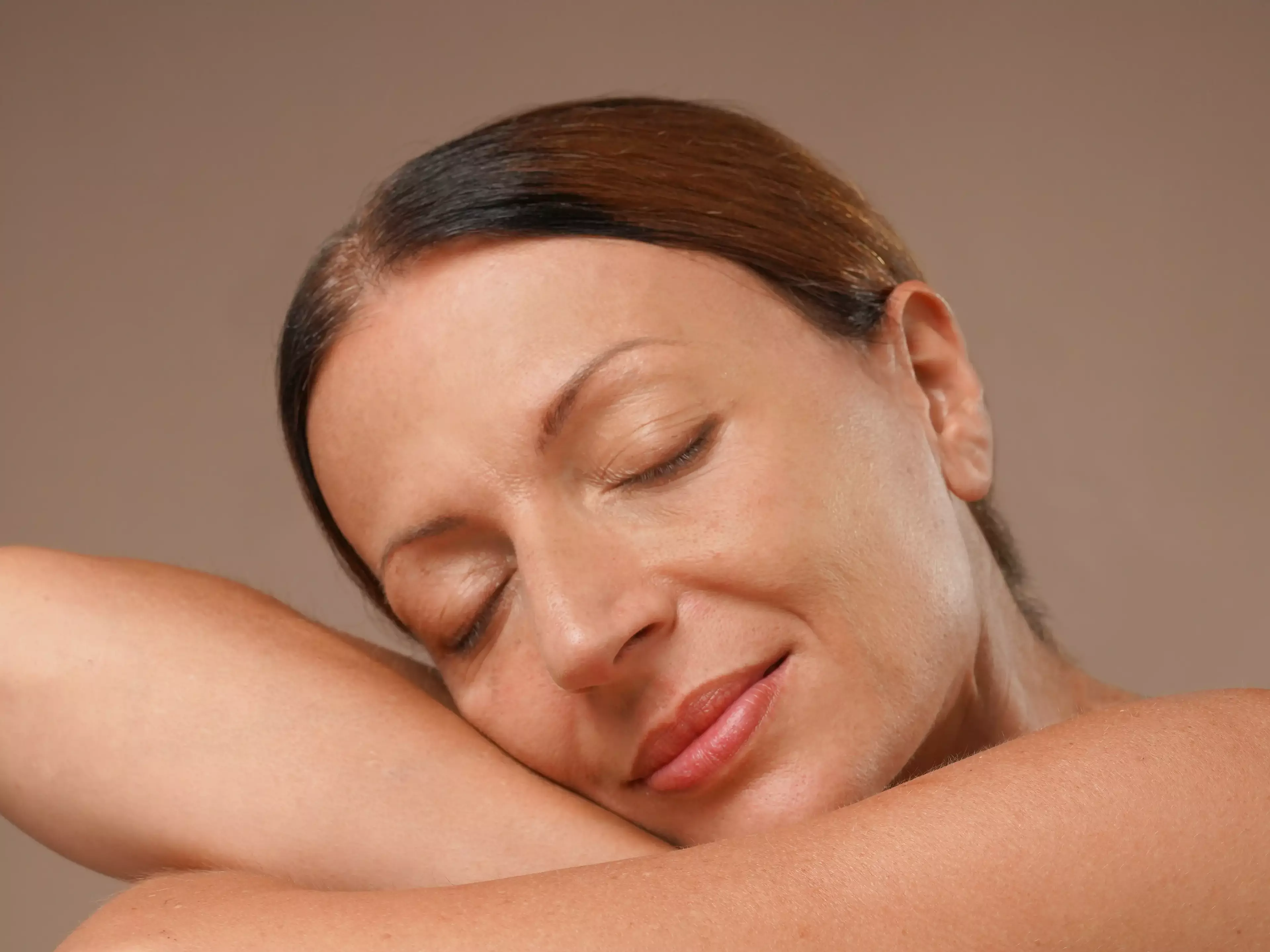 A woman with a super-fresh skin, looking calm and peaceful