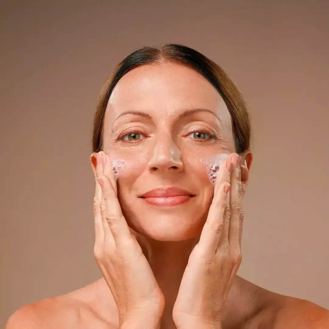 Women cleaning face with Blavana Face Cleanser theayurvedaexperience