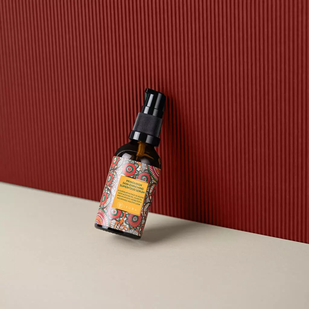 A bottle of Prinourish kept against a red corrugated background
