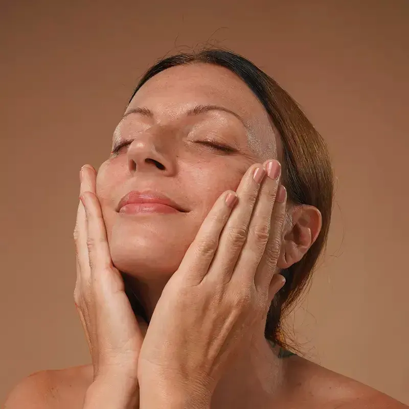 pressing oil into the face