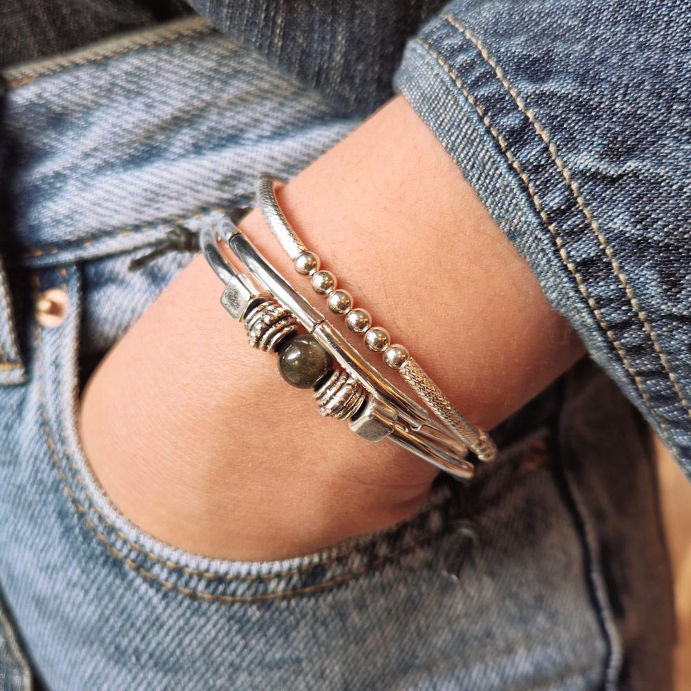 Sofi bracelet w golden obsidian next to the Lim Sterling silver bracelet