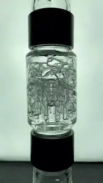 A high-definition close-up GIF of a Prism Tree Percolator in action, showing smoke being pulled through multiple vertical arms. The video illustrates the diffusion process where smoke is broken into large bubbles, maximizing surface area for the signature tree-perc "chug" and a smooth, filtered inhale.