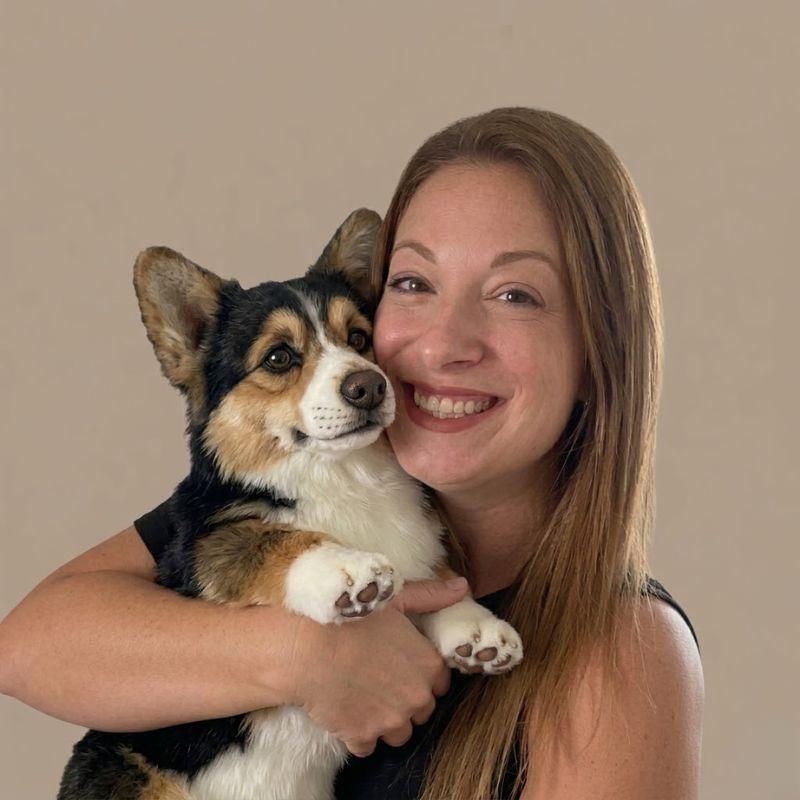 Woman holding a handmade custom stuffed animal that looks like her dog