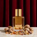 Ierofante bottle with a golden pear against a dark pleated curtain