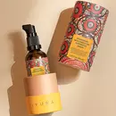 A bottle of Prinourish kept inside it's beautiful, vibrant packaging, over a beige color background
