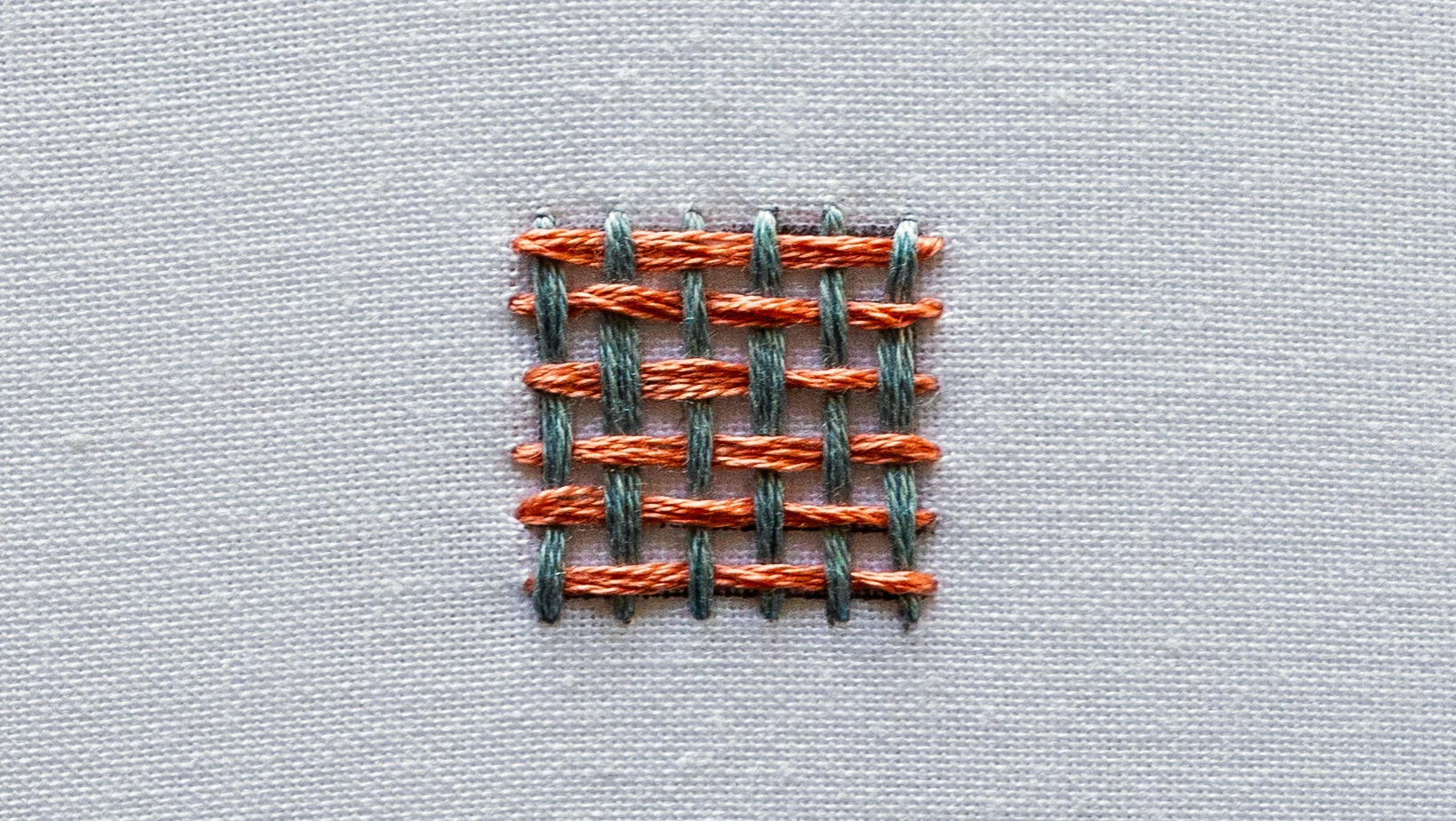 A finished shape completely filled with weave stitch