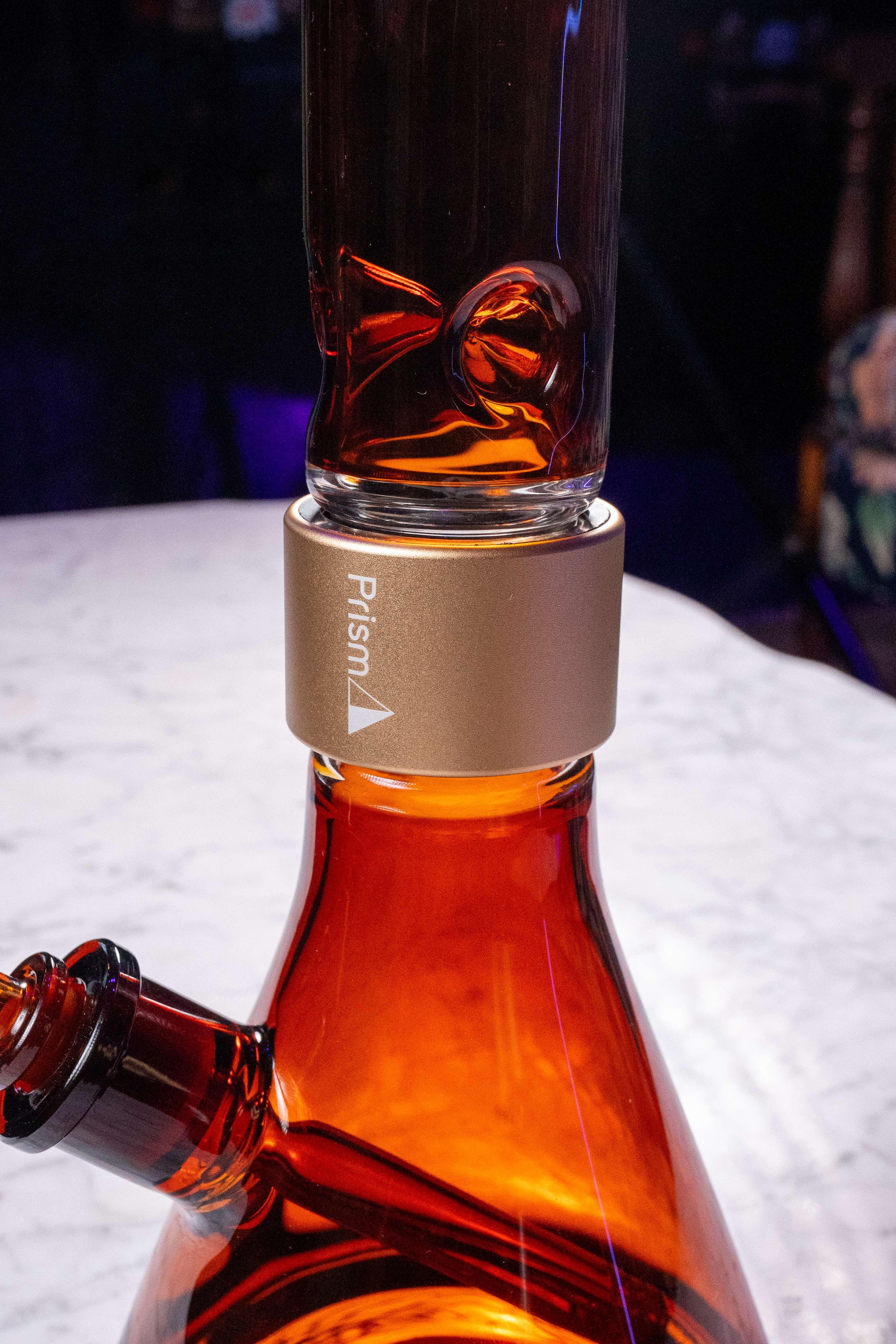 A detailed close-up of the Prism Amber Beaker base, demonstrating the color’s ability to mask resin buildup and water spots. The deep honey-tinted glass maintains a clean, photogenic appearance even after use, highlighting the low-maintenance and "stay-clean" advantages of amber borosilicate.