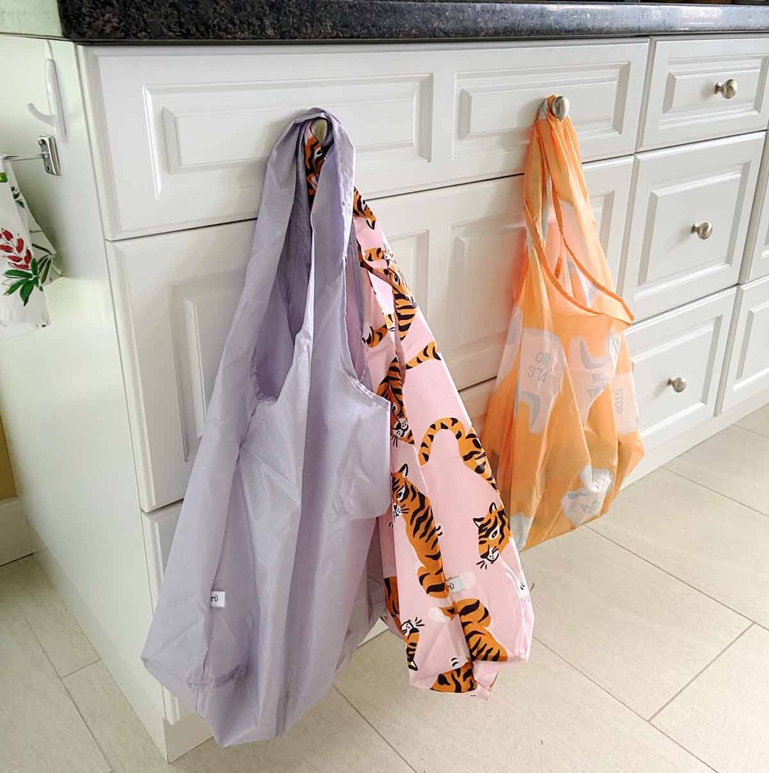 lunch totes for adults hanging in the kitchen