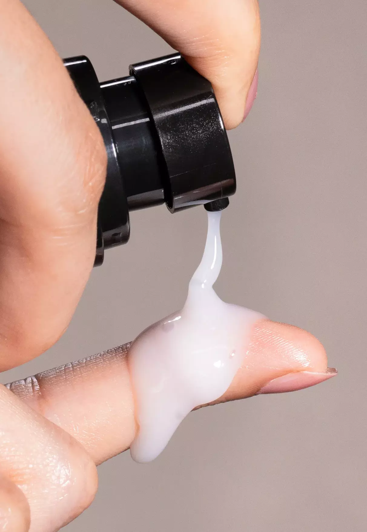 woman hand dispensing line tune face serum