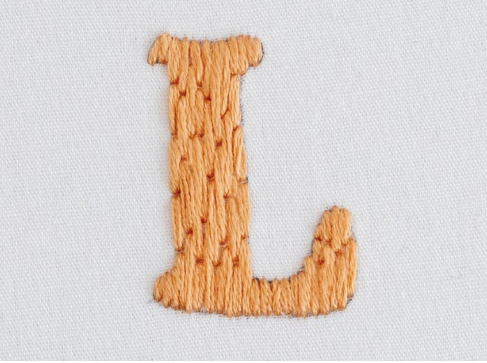 The letter L is stitched using long and short stitch.