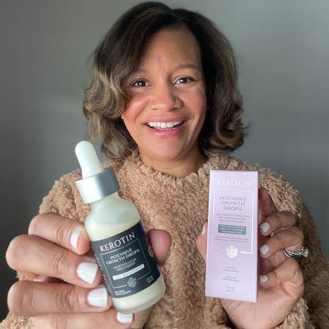 Model With Dark Hair Holding a bottle of Kerotin Hair Vitamins