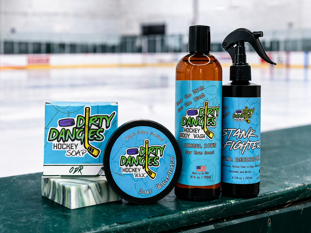 Dirty Dangles hockey soap, stick wax, body wash and gear deodorizer displayed on ice rink boards