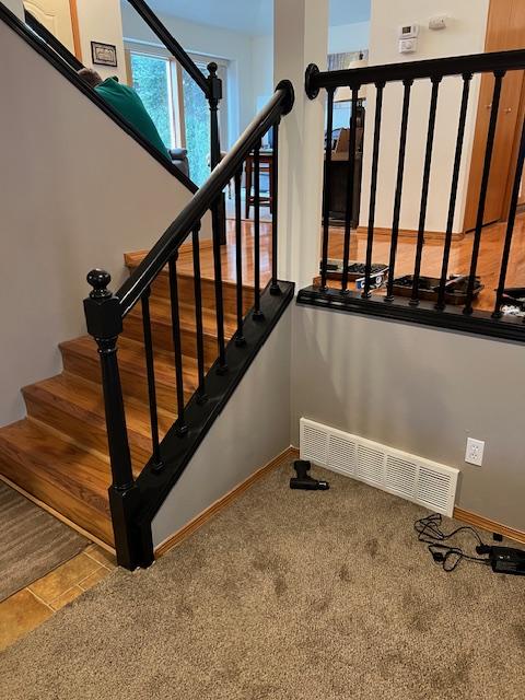 Photo of black railing within a house using snap'n lock indoor baluster line
