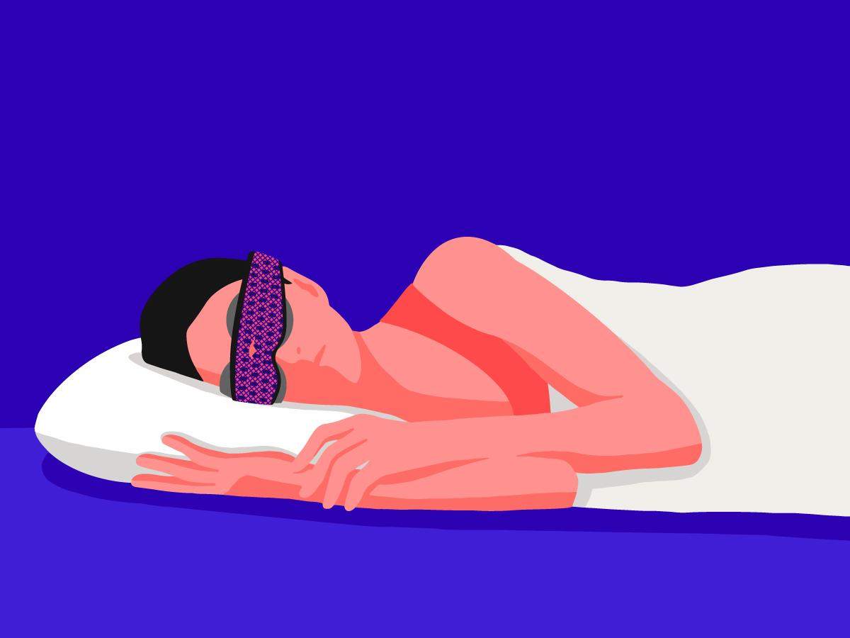 A female sleeping on her side wearing the best sleep mask for side sleepers.