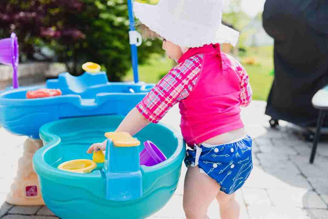 baby playing while wearing reusable swim diaper