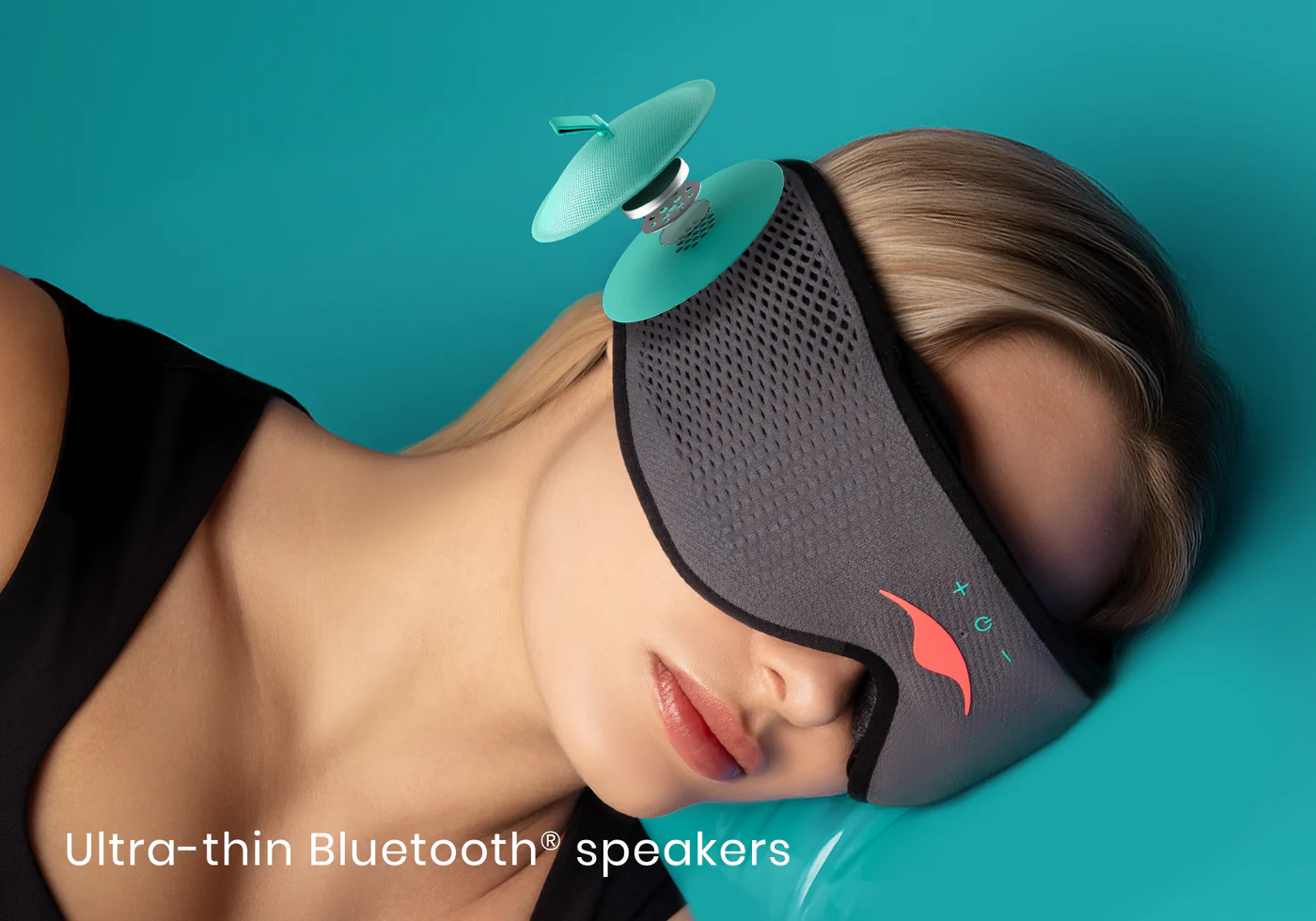 A girl wearing a gray sleep mask with Bluetooth® speakers that work for light and sound around a head.