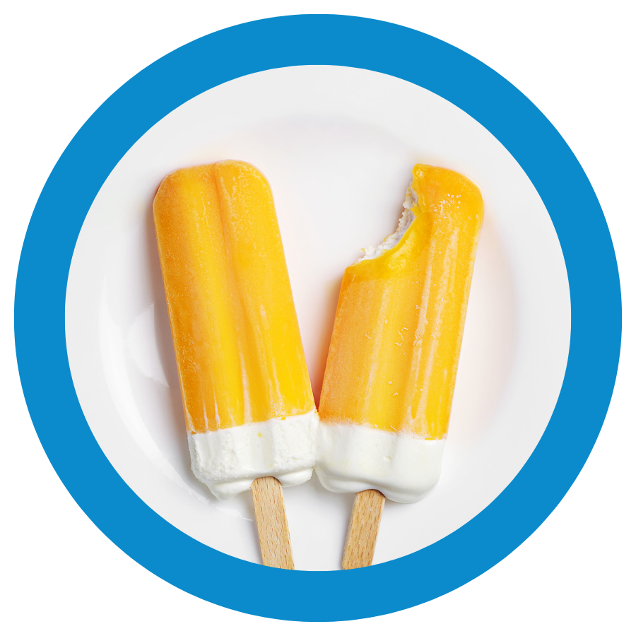 Two orange cream popsicles on a plate.