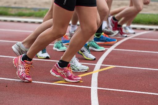walking to running on a track tennis shoes runner