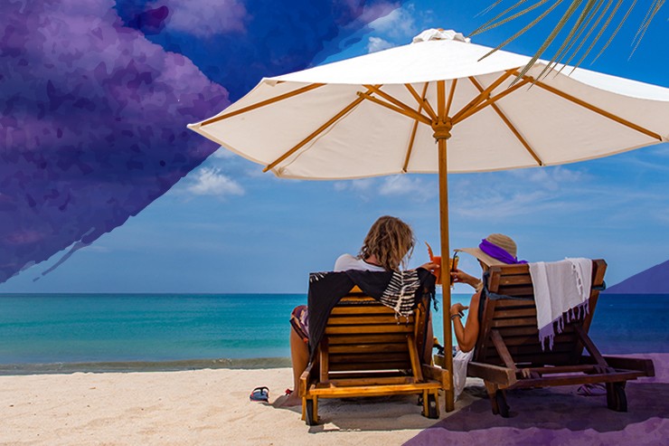 couple vacation beach umbrella with drinks