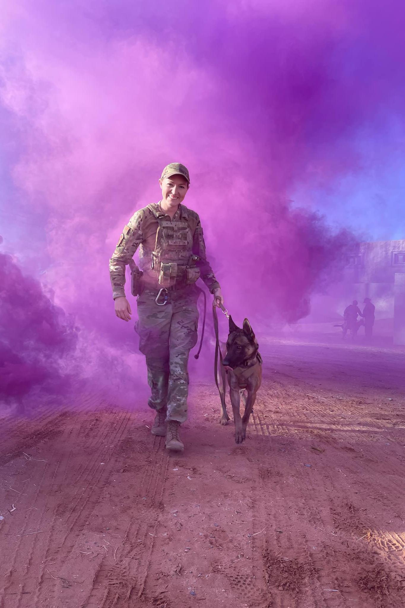 mwd rudy and handler in a cloud of purple smoke