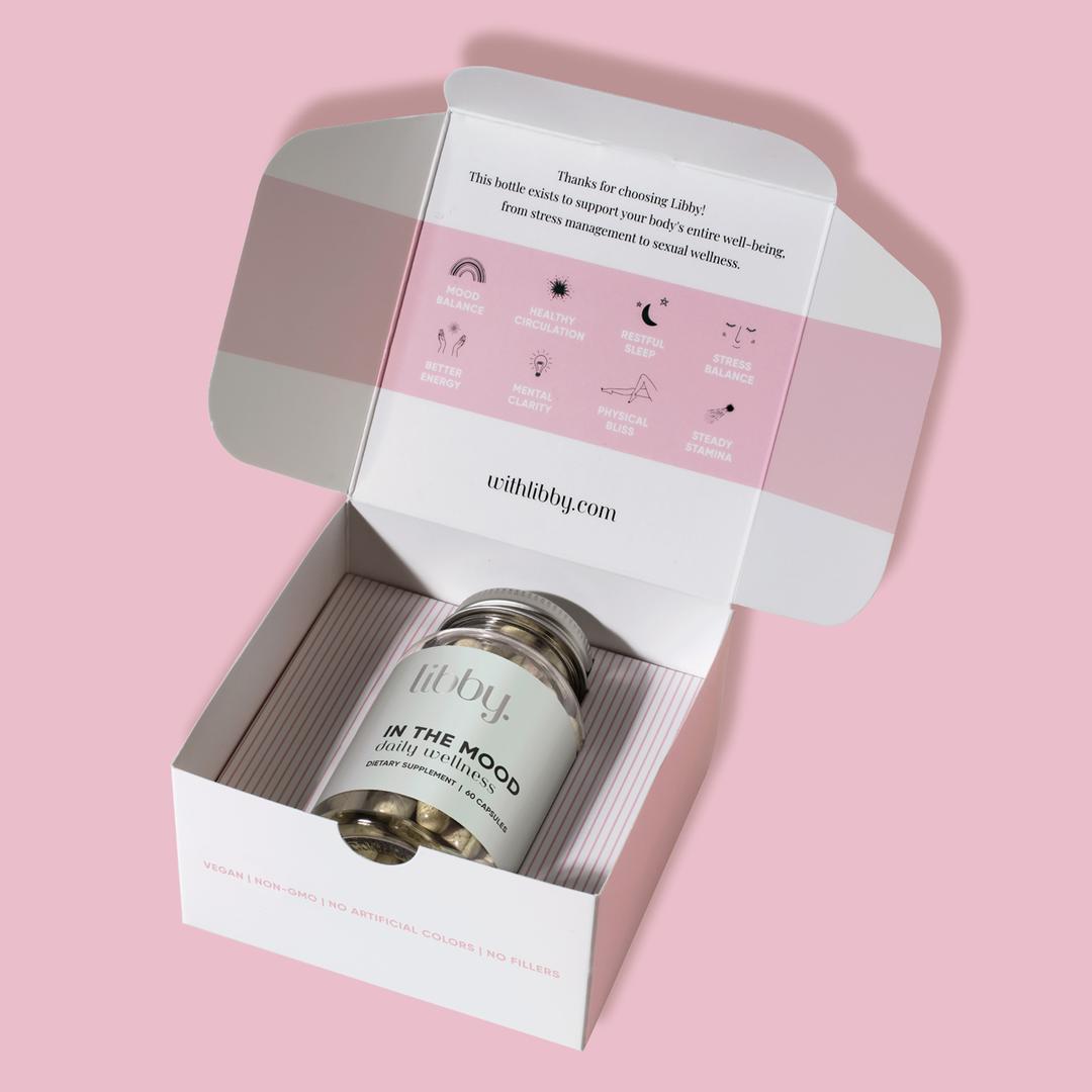 Bottle of Libby capsules in its packaging on a pink background.