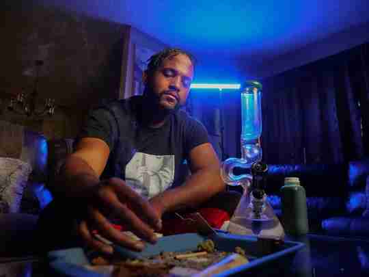 man prepping weed bong