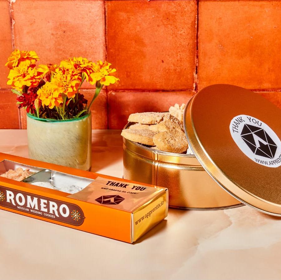 tin of cookies with logo on orange background