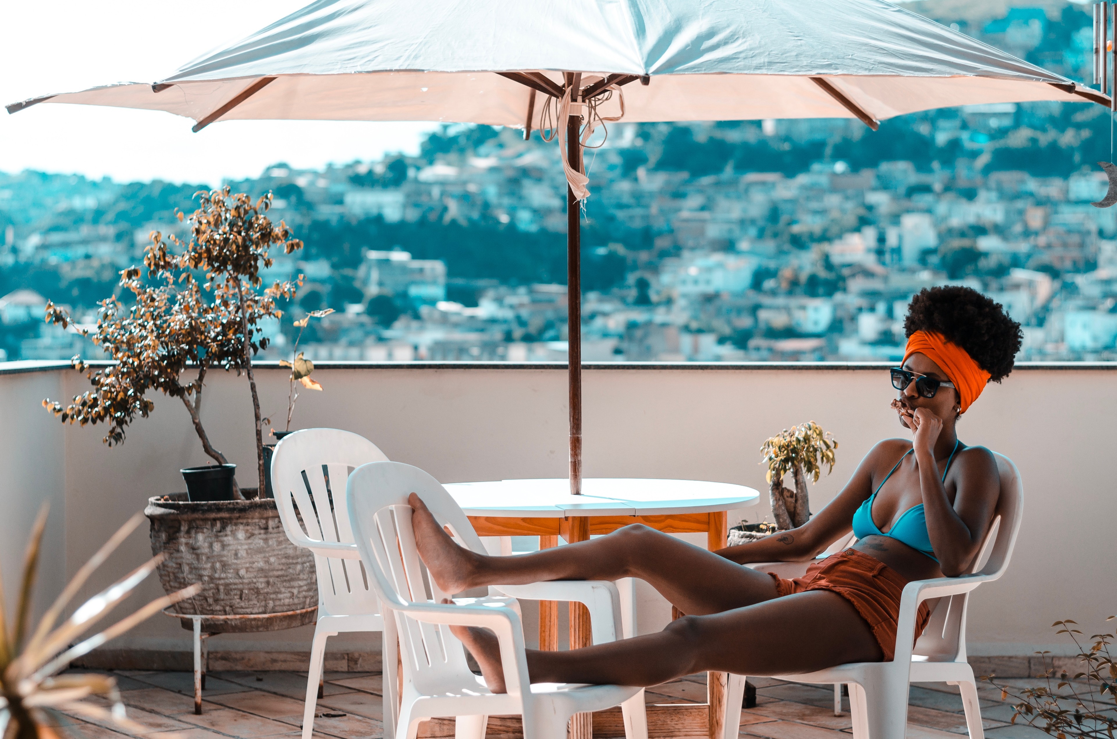 black woman with natural hair sitting in chair outside on vacation