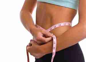 fat loss losing weight woman with measuring tape around waist