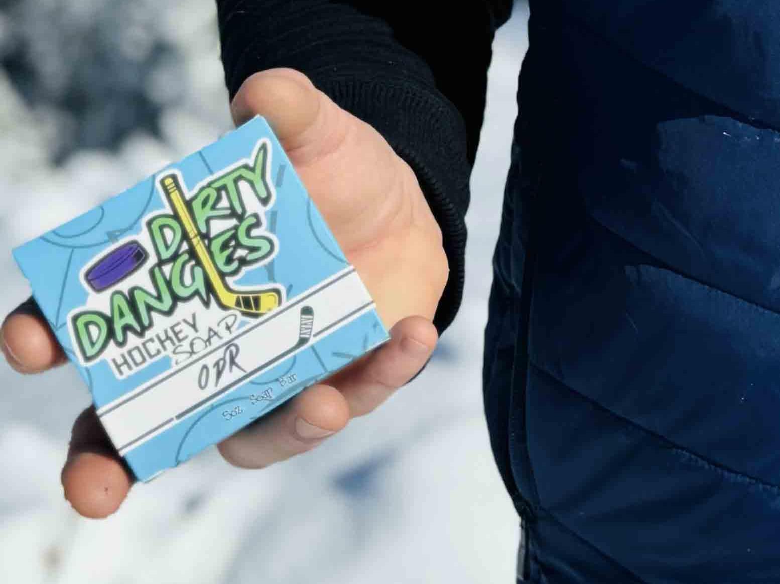 A hockey player holding a box of odr hockey soap.