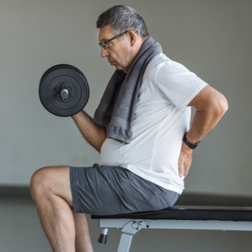older man weight-lifting while his back hurts