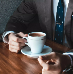 Man in Business Suit Drinking Coffee