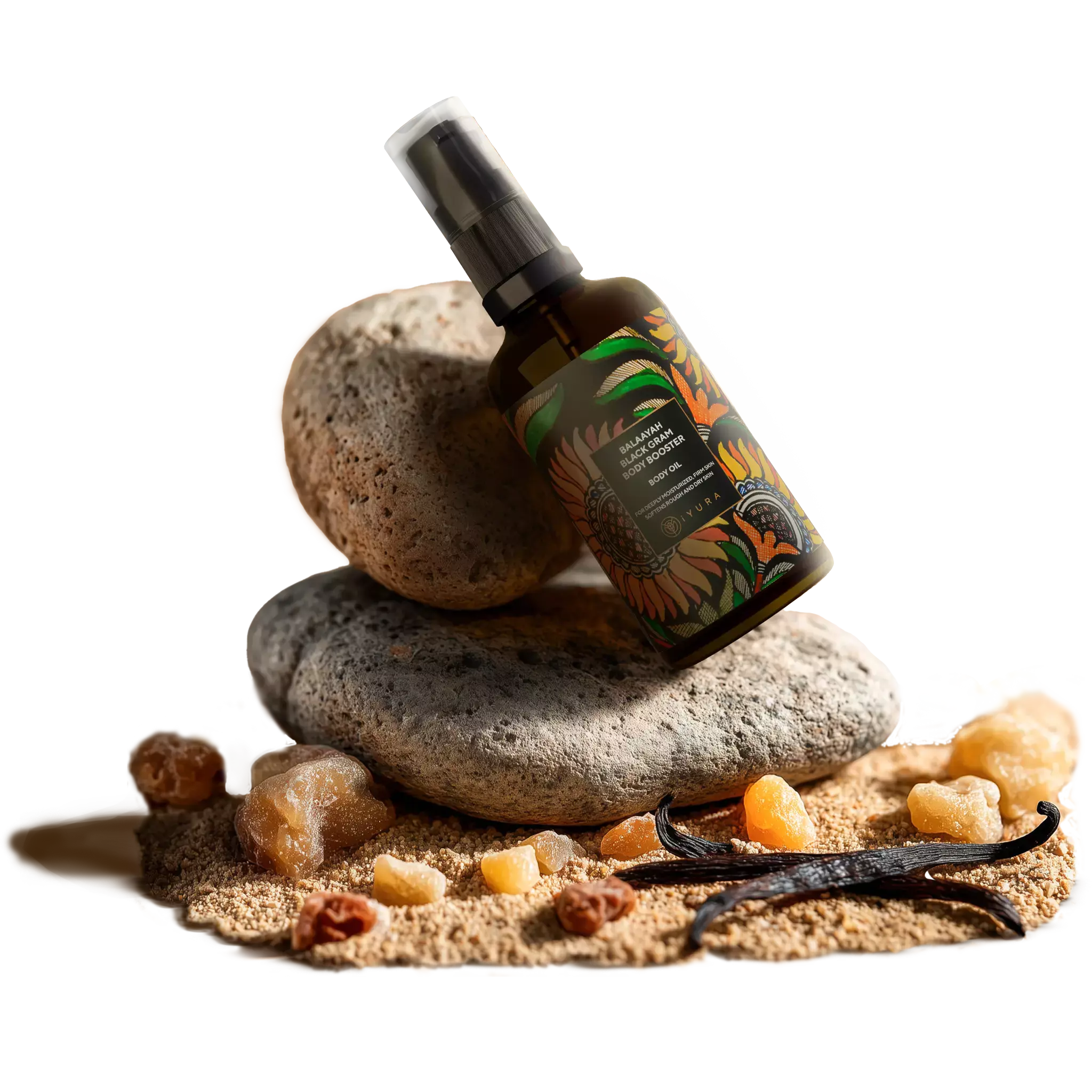 An aesthetic composition on a bottle of Balaayah supported over porus rocks surrounded by sand, frankincense and vanilla beans