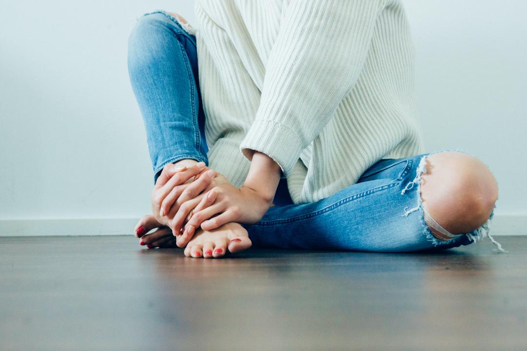Woman holding foot in pain