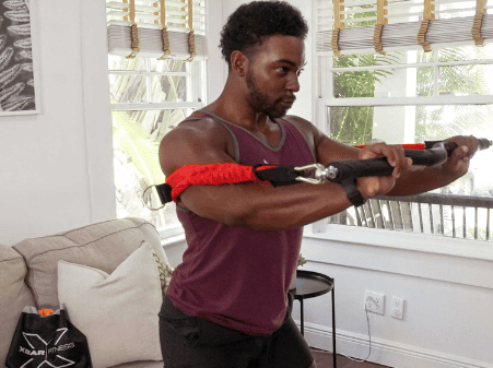 man using xbar to perform a chest press