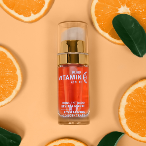 Noche's Vitamin C Serum on light orange background surrounded by orange slices.