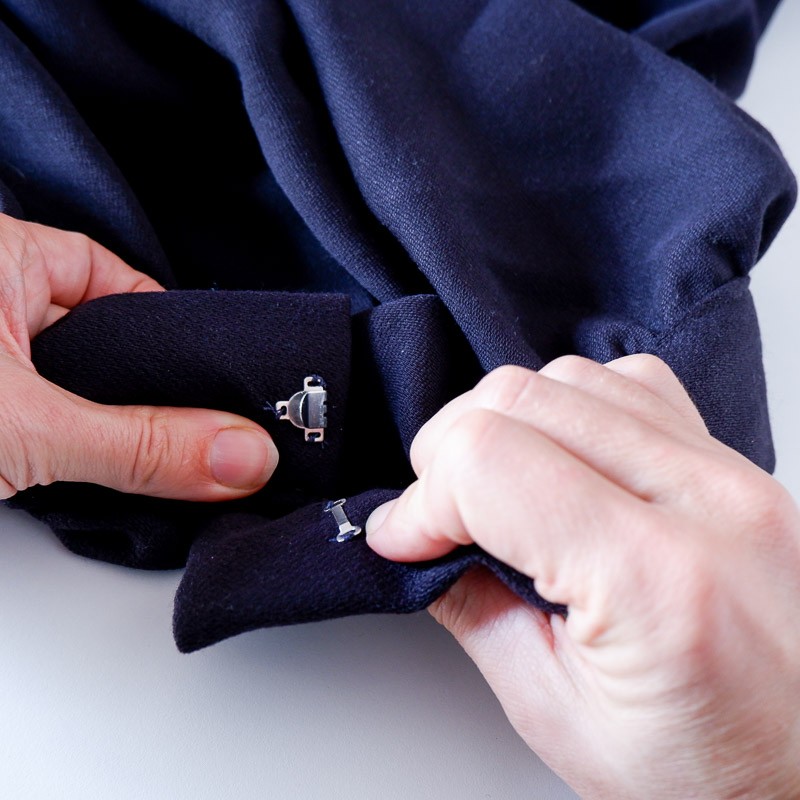 Hook and bar sewn onto a waistband/garment that has a zipper