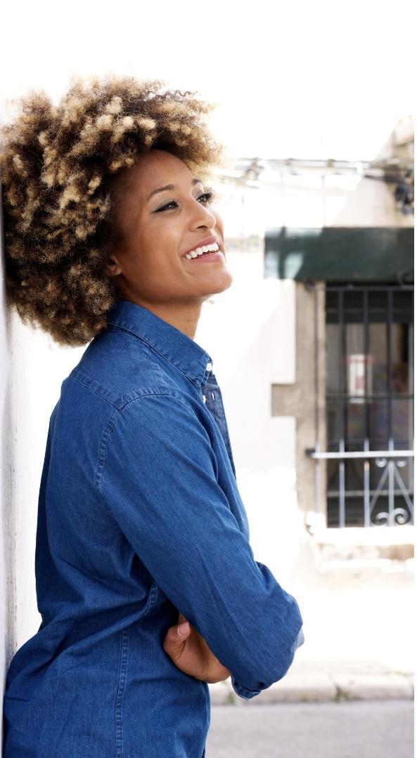 Midlife Black woman with thriving natural curls.