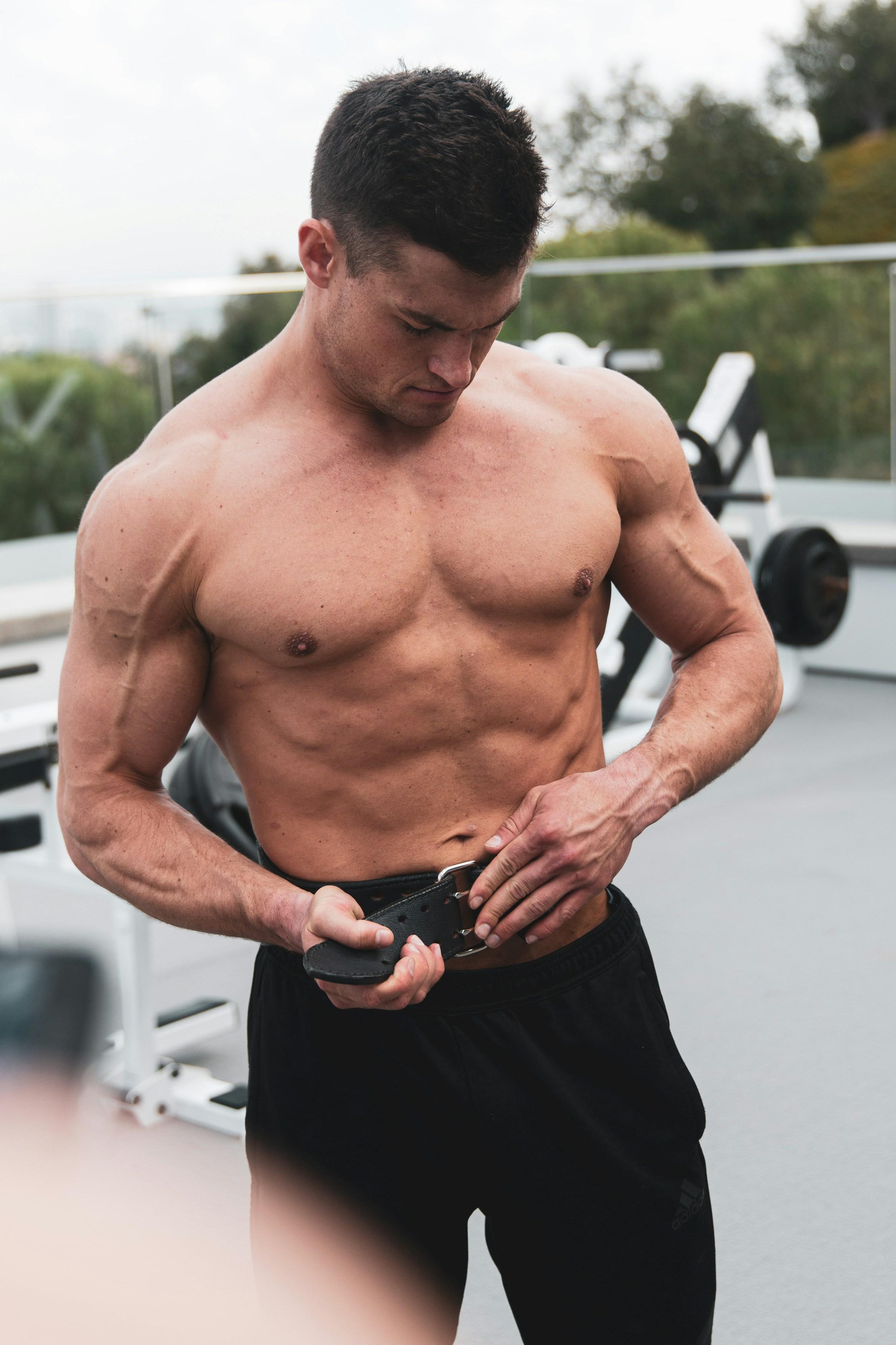 man putting on weight belt