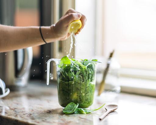 spinach in a blender with greens lemon juice