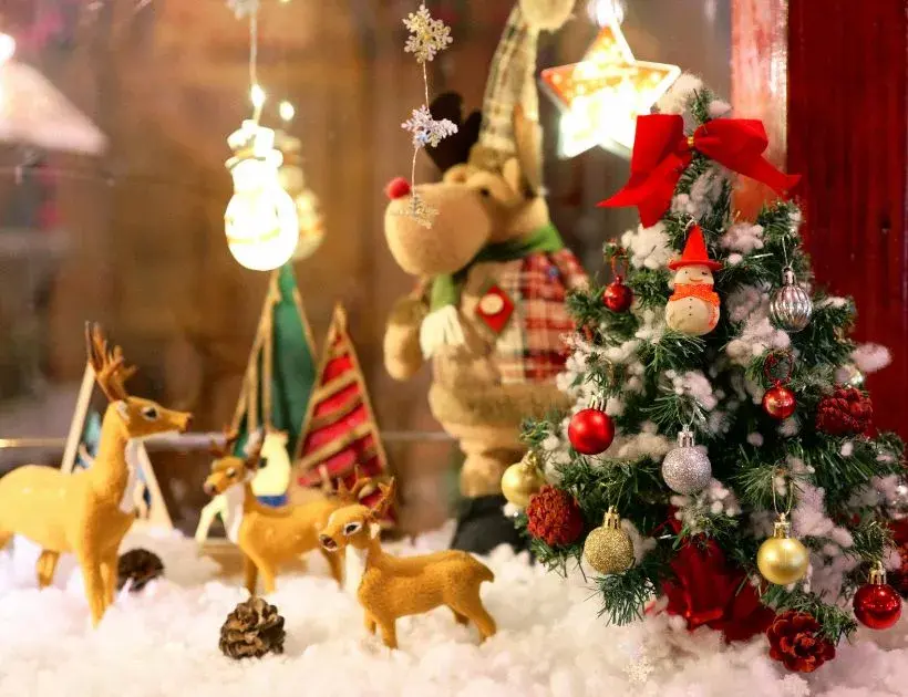 Festive Christmas window decorations featuring colorful lights, ornaments, and snowflakes creating a cheerful holiday atmosphere.