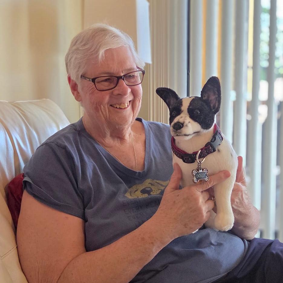 Happy customer holding their custom pet plush
