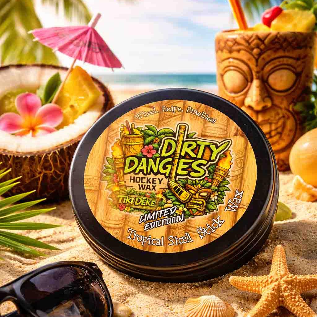 A tin of dirty dangles tiki deke limited edition tropical stick wax on a beach with tiki drinks and sea shells.