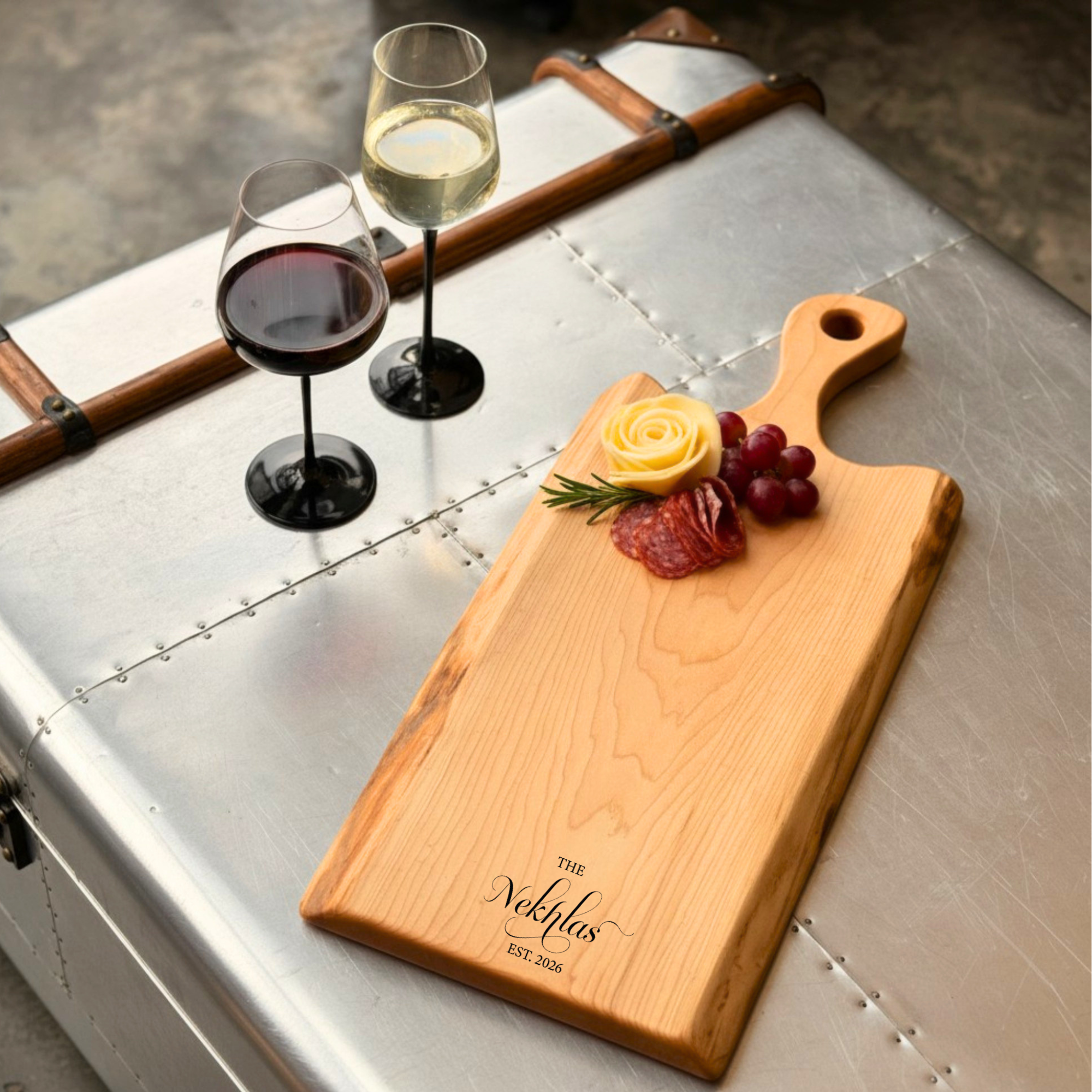 Personalized live edge maple cutting board with carved out handle. Styled with charcuterie, perfect for wedding and housewarming gift ideas